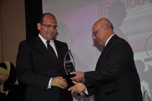 Ahmed Ismail Hassan, NBAD's Regional Manager in Egypt, (Left) receives the award on behalf of NBAD Asset Management Group.